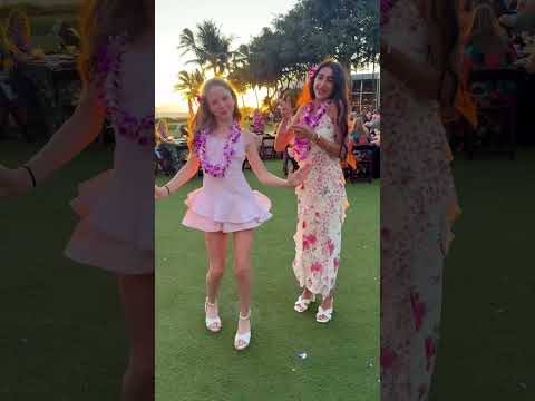 Nastya and Eva dancing at a Hawaiian party